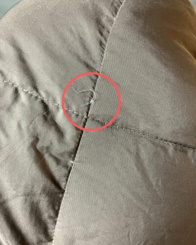 2年前に購入した羽毛肩当てに小さな穴が空いて羽毛が少し出てる様子