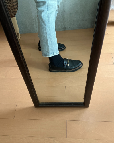 細身ジーンズの下にレッグウォーマーと靴下を着用して、ローファーを履いた様子（横から）